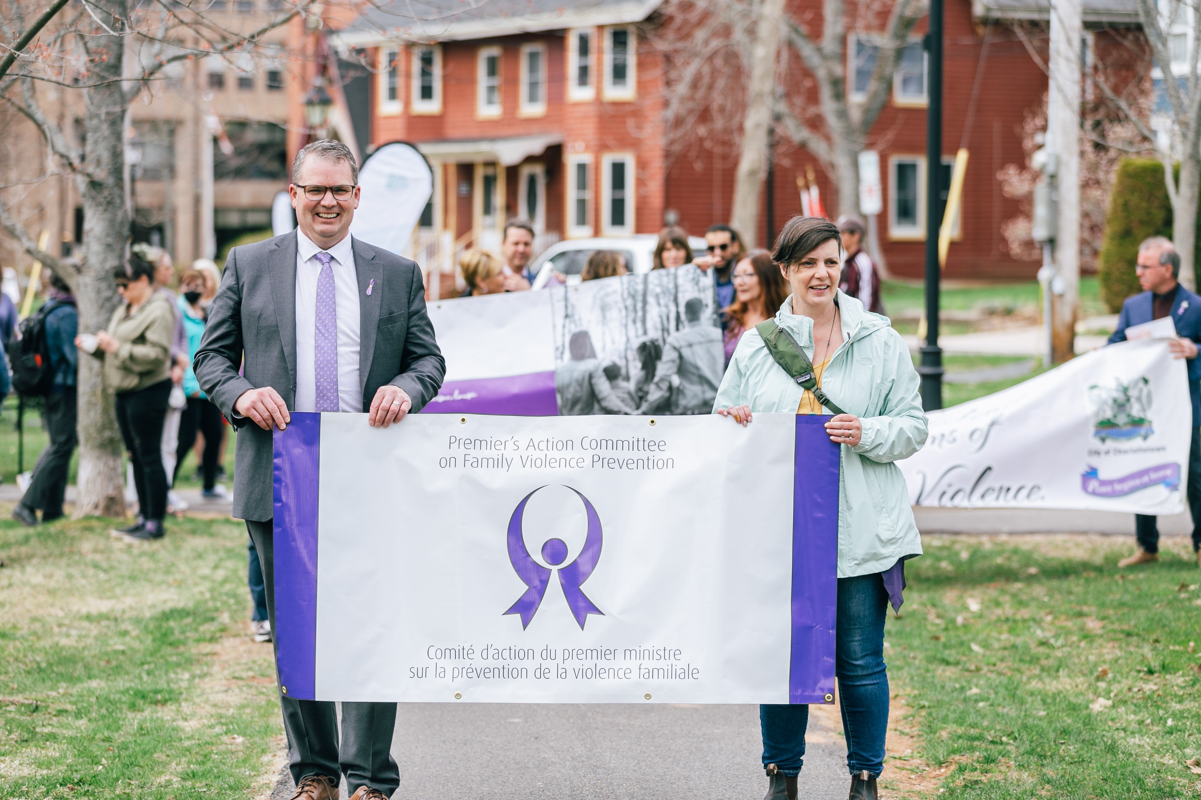 Family Violence Prevention Week 2022- Walk in Silence (Charlottetown) Participants holding PAC on Family Violence Prevention Banner. 