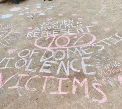chalk writing on pavement in support of family violence prevention